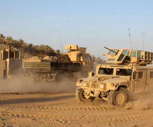 military vehicles driving in the desert