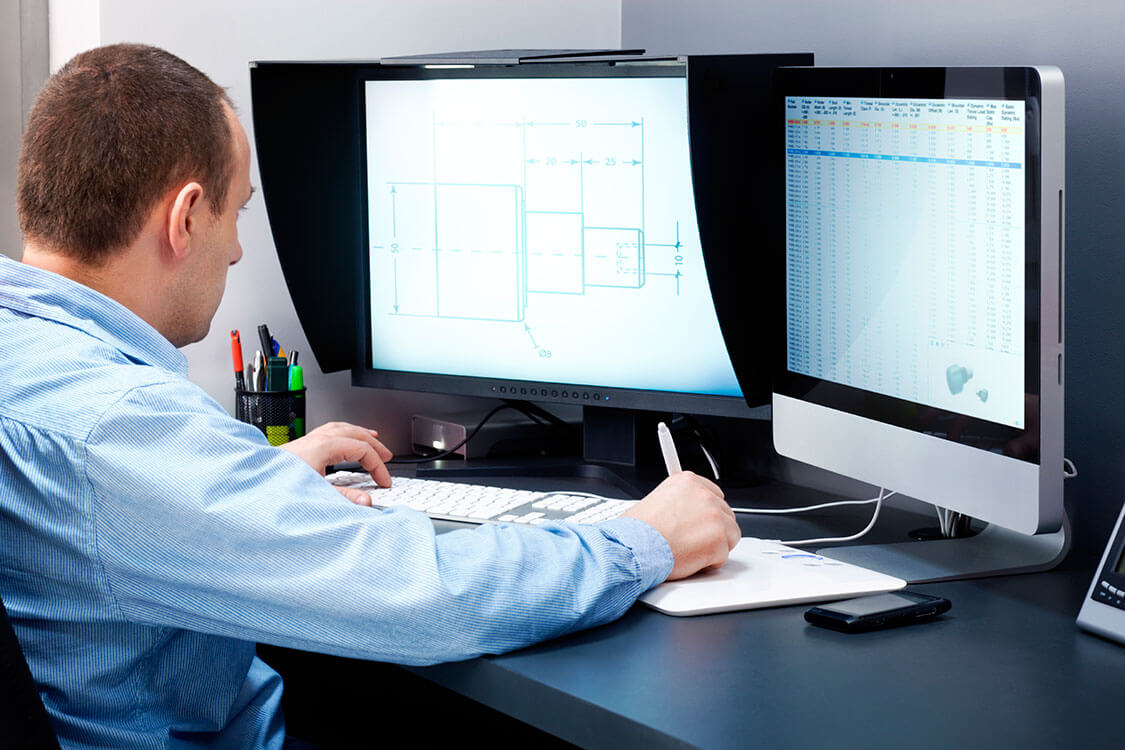 man sitting at computer desk